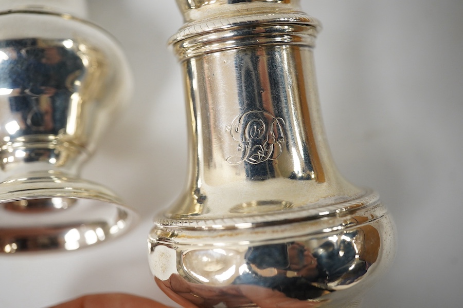Two George III silver sugar casters, tallest 13.9cm, Thomas Daniell, London, 1775 and London, 1768. Condition - poor to fair
